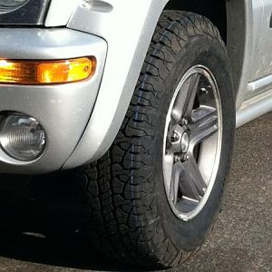 They are BF Goodrich Rugged Terrain's. Just stock size 235/75r16