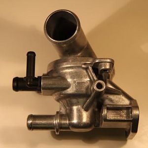 PHOTO OF THE OTHER SIDE VIEW OF THE ORIGINAL EQUIPMENT ENGINE THERMOSTAT ASSEMBLY