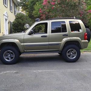 Finally got around to getting off-road tires.  Lucky enough to have two complete sets of matching Renegade wheels.  She looks much better now.