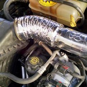 A 2004 intake tube wrapped with DEI CoolTape.