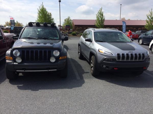 2" lifted KJ parked next to a Cherokee Trailhawk.