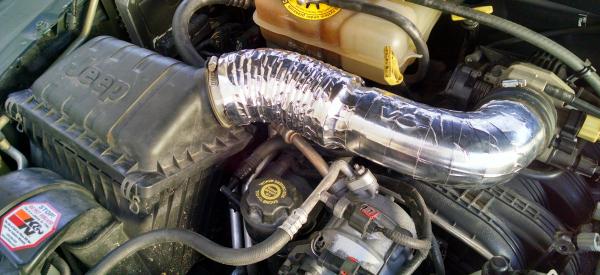 A 2004 intake tube wrapped with DEI CoolTape.