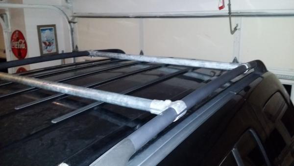 Custom made roof cross bars. Total: around $20-$30 if you don't have two metal poles laying around like I did. :)