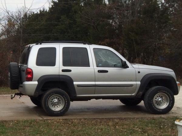 image 02 Sport. Rebuilt engine/2 1/2" lift/bumpers and flares from a Limited. I sanded nicks and scratches out of the flares and shot them flat black.