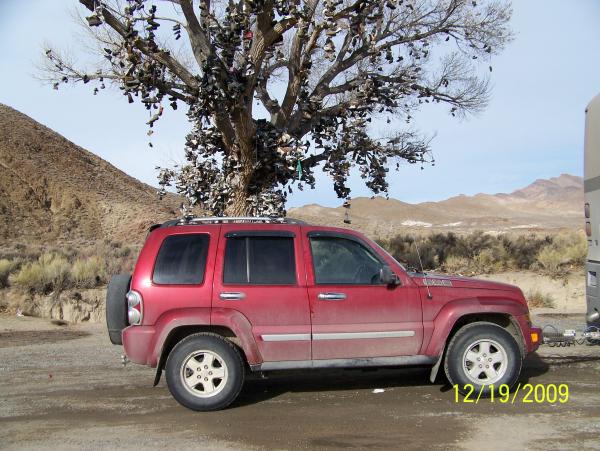 Jeep in front of the shoe tree on Hwy 50 in Nevada