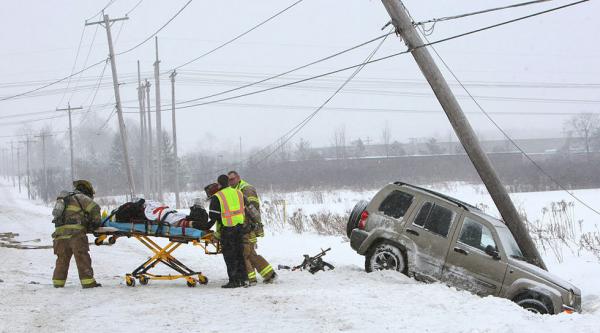 Slippery roads put this woman into a Liverpool, NY power pole