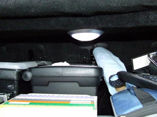 Tap light mounted under the cargo shelf